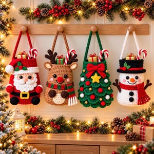 May include: Four crocheted Christmas hanging baskets featuring a Santa Claus, a reindeer, a Christmas tree, and a snowman. Each basket has a handle, a candy cane, and a small gift box inside, all suspended from a wooden wall hook rack.