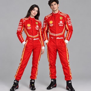 May include: Two individuals wearing matching bright red Ferrari racing jumpsuits featuring white and yellow stripes, a high collar, and various sponsor logos including Shell, Santander, and Puma. The jumpsuits have long sleeves and black racing boots.