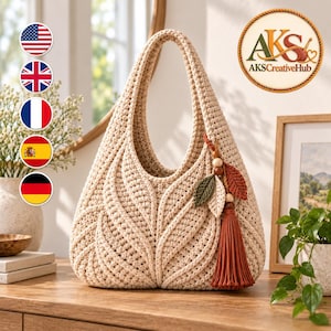 May include: A beige crochet handbag featuring a textured leaf pattern on the front. The bag has a single integrated handle and is decorated with a hanging charm consisting of wooden beads, two small fabric leaves in green and beige, and a long tassel.