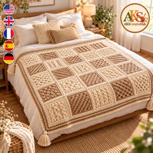 May include: A crochet blanket featuring a grid of alternating cream and tan square panels with varied textured stitch patterns, including cables and bobbles, finished with a decorative border and tassels at each corner of the rectangular throw.