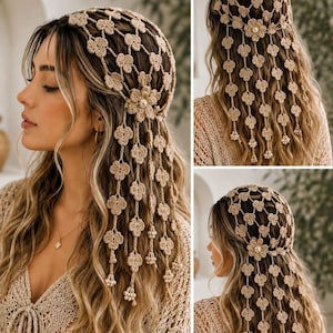 May include: A beige crochet headpiece featuring a delicate floral pattern with interconnected mesh sections. The design includes dangling strands of small crocheted flowers finished with tiny white beads at the ends and a central flower accent.