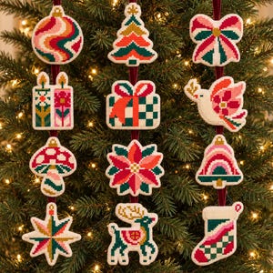 May include: A collection of twelve cross-stitch Christmas ornaments featuring various shapes including a round bauble, tree, bow, candles, gift, dove, mushroom, poinsettia, bell, star, reindeer, and stocking in red, green, pink, and white.