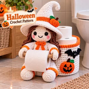 May include: A crochet doll wearing a white witch hat with an orange pumpkin accent, holding a roll of toilet paper. Beside the doll is a white cylindrical crochet basket decorated with a black bat and an orange jack-o'-lantern, holding two rolls of toilet paper. The text "Halloween Crochet Pattern" is visible.