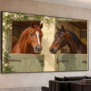Puede incluir: Una impresión de arte mural rectangular que muestra dos caballos en establos de madera adyacentes. Un caballo alazán con una mancha blanca en la cara está a la izquierda y un caballo marrón oscuro a la derecha. Flores blancas enmarcan las puertas.