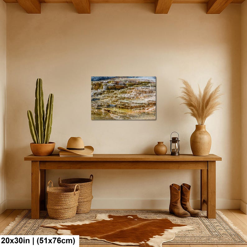 May include: A rectangular wall art print depicting a layered geothermal terrace with mineral deposits in shades of brown, tan, and white. The print measures 20 by 30 inches and is displayed on a beige wall above a wooden console table.