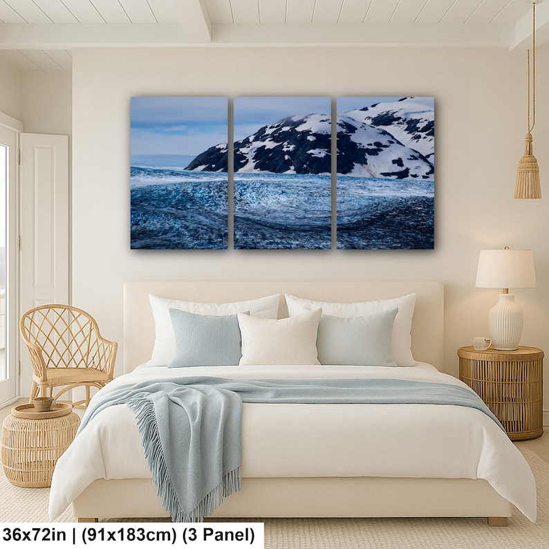 May include: A three-panel wall art set depicting a snowy mountain landscape with a dark blue glacier in the foreground. The artwork measures 36 by 72 inches and features a high-contrast scene of white snow-capped peaks against a blue sky.