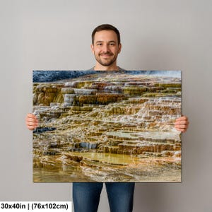 May include: A rectangular wall art print measuring 30x40 inches featuring a landscape photograph of tiered mineral terraces with shades of yellow, orange, brown, and white, showing water flowing over the textured, layered rock formations.