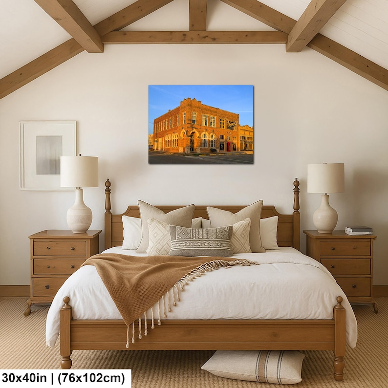 May include: A rectangular wall art print featuring a multi-story brick building illuminated by warm golden hour sunlight against a clear blue sky. The artwork is displayed in a bedroom setting, with dimensions of 30 inches by 40 inches noted below.