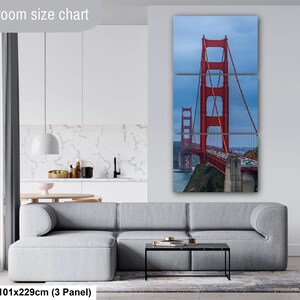 May include: A three-panel wall art set depicting the red Golden Gate Bridge against a blue sky. The text "Livingroom size chart" appears at the top left, and "40x90in | 101x229cm (3 Panel)" is printed at the bottom left of the image.