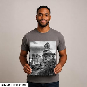 May include: A rectangular wall art print measuring 16 inches by 20 inches, featuring a black and white landscape photograph of tall, weathered rock formations under a cloudy sky, with sparse vegetation in the foreground and textured stone cliffs.
