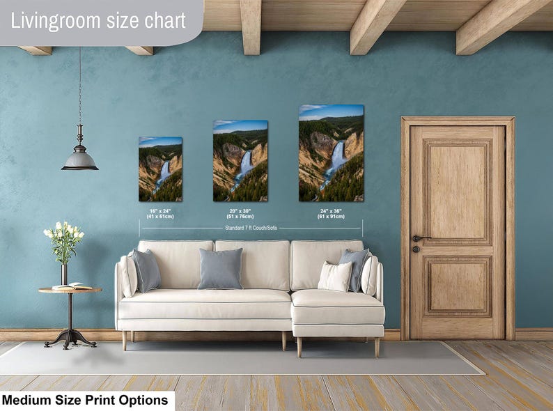 May include: A living room size chart displaying three vertical wall art prints of a waterfall in a canyon, with dimensions of 16 x 24 inches, 20 x 30 inches, and 24 x 36 inches, positioned above a white sectional sofa with gray and white pillows.