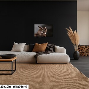 May include: A rectangular wall art print featuring a detailed photograph of a great horned owl with yellow eyes and brown, black, and white feathers. The print measures 20 by 30 inches and is displayed on a dark wall above a light-colored sofa.