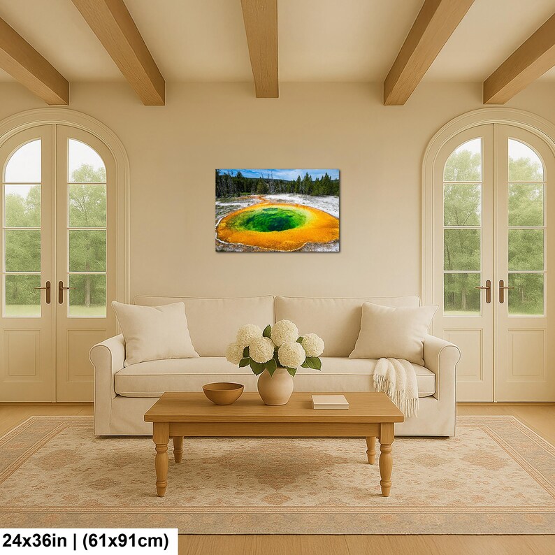 May include: A rectangular wall art print featuring a vibrant geothermal hot spring with a deep green center surrounded by bright orange and yellow mineral deposits, set against a backdrop of dark green pine trees and a clear blue sky.