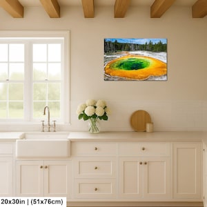 May include: A rectangular wall art print featuring a vibrant geothermal pool with a deep green center surrounded by bright orange and yellow mineral deposits, set against a backdrop of dark green pine trees and a clear blue sky.
