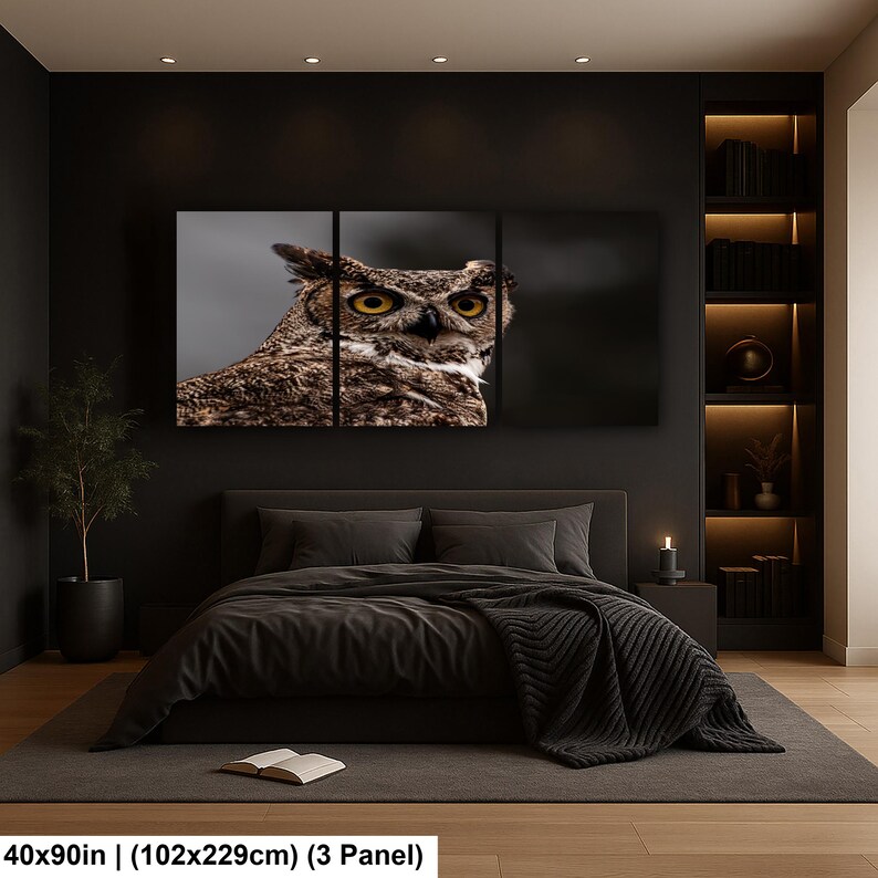 May include: A three-panel wall art set featuring a close-up photograph of a brown and white owl with large yellow eyes. The artwork measures 40 by 90 inches and is displayed above a bed in a dark room with integrated shelving and lighting.