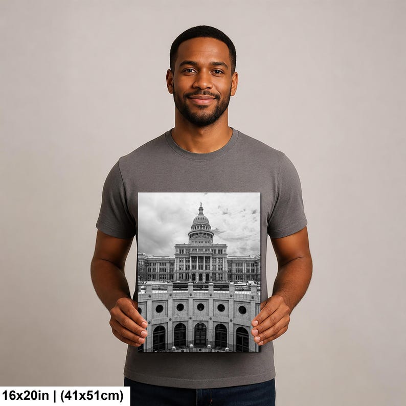 May include: A rectangular wall art print featuring a black and white photograph of the Texas State Capitol building with its prominent dome and architectural facade. The print measures 16 inches by 20 inches and displays a detailed view.