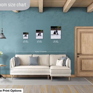 May include: A living room size chart displaying three rectangular wall art prints featuring orca whales above a cream-colored sectional sofa. The prints are labeled with dimensions 8 x 10 inches, 11 x 14 inches, and 16 x 20 inches respectively.