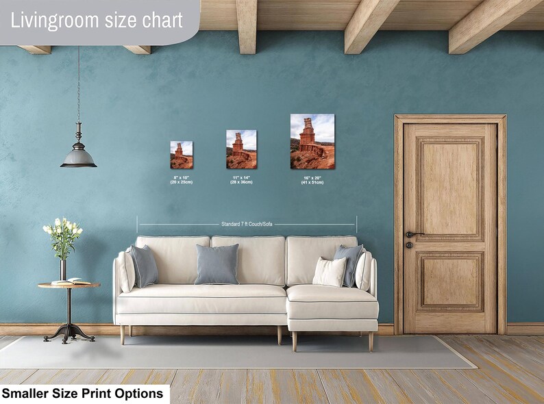 May include: A living room size chart displaying three framed landscape prints of a desert rock formation above a cream-colored sectional sofa. The prints are labeled with dimensions of 8x10 inches, 11x14 inches, and 16x20 inches for size comparison.