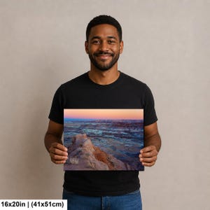 May include: A rectangular wall art print measuring 16 inches by 20 inches, featuring a landscape photograph of a desert canyon at sunset with layered rock formations in shades of orange, blue, and purple under a soft gradient sky.
