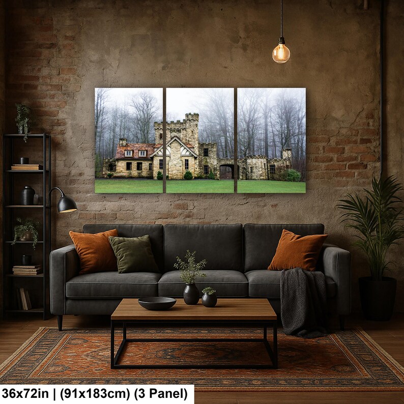 Op de afbeelding: Een driedelige wandkunstset met een stenen kasteel met een rood dak, omringd door een mistig bos en een groen gazon. Het kunstwerk meet 91 bij 183 cm en toont een gedetailleerde architecturale structuur met meerdere ramen en torens.