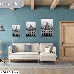 May include: A living room size chart displaying three black and white wall art prints of a domed building. The prints are labeled with dimensions of 16 by 24 inches, 20 by 30 inches, and 24 by 36 inches, positioned above a cream-colored sectional sofa.