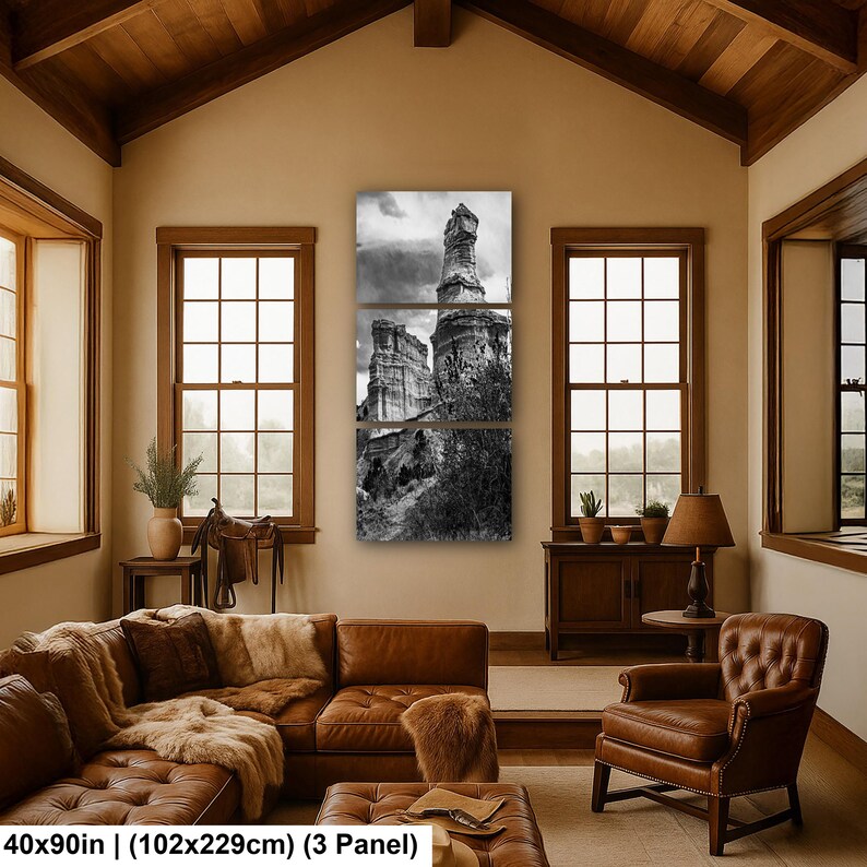 May include: A three-panel black and white wall art set depicting a tall, weathered rock formation under a cloudy sky. The artwork measures 40 by 90 inches in total, featuring a vertical landscape composition with textured stone cliffs and foliage.