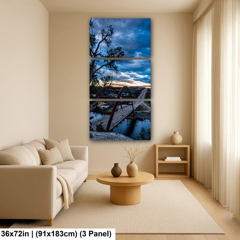 May include: A three-panel wall art set depicting a bridge over water at twilight. The image features a dark blue cloudy sky, a red arched bridge structure, and a road with vehicles. The total dimensions are 36 by 72 inches for the three panels.
