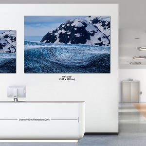May include: Two rectangular landscape wall art prints featuring a snowy mountain peak above a dark blue glacial ice formation. The smaller print is 30 x 40 inches and the larger print is 40 x 60 inches, displayed above a 5 ft reception desk.