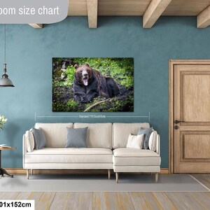 May include: A rectangular wall art print featuring a brown bear yawning in a grassy field, displayed above a cream-colored sectional sofa. The print is labeled as 40x60 inches and 101x152 cm, showing a standard 7-foot couch for scale reference.