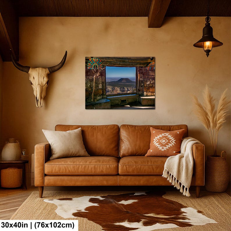 May include: A rectangular wall art print featuring a desert landscape view through a stone window frame, displayed above a brown leather sofa. The artwork measures 30 inches by 40 inches and depicts a mesa under a clear blue sky.