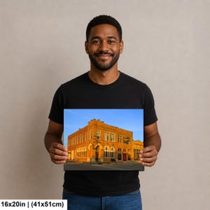 May include: A rectangular wall art print featuring a historic orange brick building under a clear blue sky. The print measures 16x20 inches and displays architectural details including arched windows and a corner entrance on a city street.