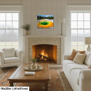 May include: A rectangular wall art print featuring a vibrant landscape of a geothermal hot spring with a deep green center surrounded by bright orange and yellow mineral rings, set against a backdrop of dark green pine trees and a blue sky.