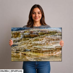 May include: A rectangular wall art print measuring 24 by 36 inches, featuring a high-resolution landscape photograph of mineral-rich geothermal terraces with layered, stepped pools in shades of orange, yellow, brown, and white, with water flowing.