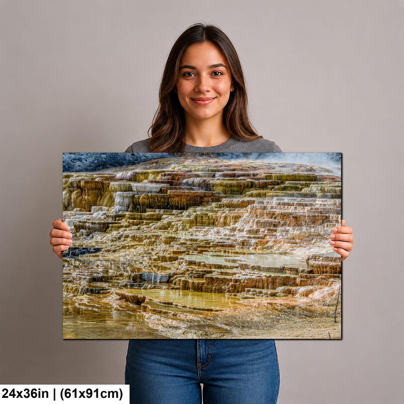 May include: A rectangular wall art print measuring 24 by 36 inches, featuring a high-resolution landscape photograph of mineral-rich geothermal terraces with layered, stepped pools in shades of orange, yellow, brown, and white, with water flowing.