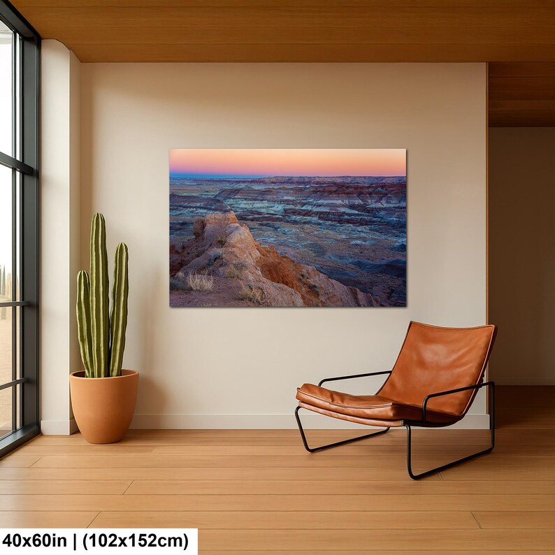 May include: A rectangular wall art print measuring 40 by 60 inches, featuring a landscape photograph of a desert canyon at sunset with layered rock formations in shades of orange, blue, and purple under a soft gradient sky.