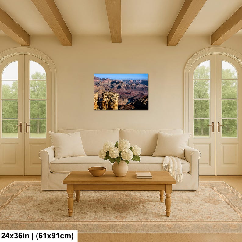 May include: A rectangular wall art print featuring a landscape photograph of the Grand Canyon with deep red rock formations, shadows, and a bright blue sky. The print measures 24 inches by 36 inches and is displayed on a neutral wall.