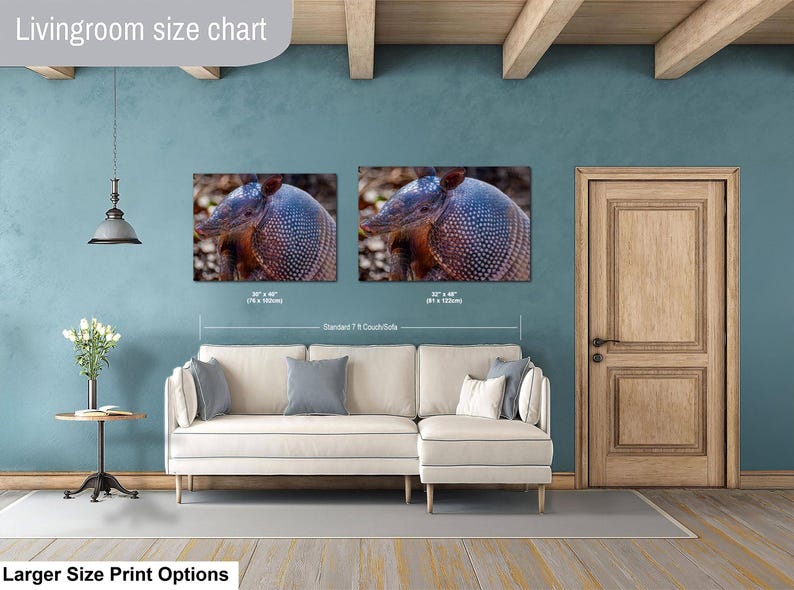May include: A living room size chart featuring two rectangular wall art prints of an armadillo displayed above a cream-colored sectional sofa. The prints are labeled with dimensions of 30 x 40 inches and 32 x 48 inches, showing scale relative to a 7-foot couch.