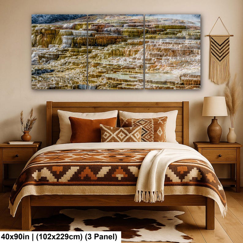 May include: A three-panel wall art set depicting a landscape of layered mineral terraces in shades of brown, tan, and white. The artwork is displayed above a wooden bed frame with a brown and white patterned blanket and matching throw pillows.