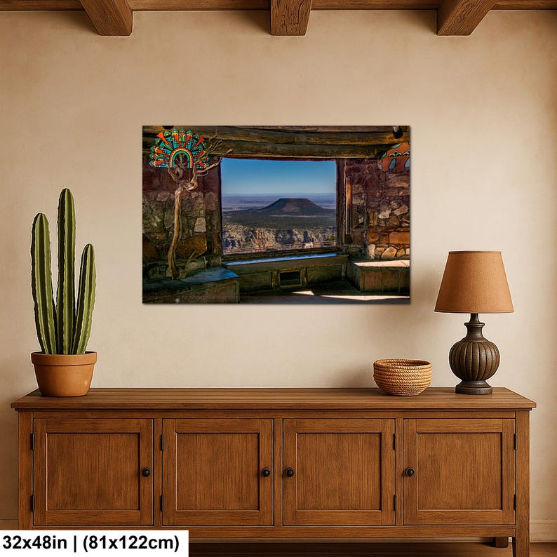 May include: A rectangular wall art print measuring 32 by 48 inches, depicting a stone-walled interior view looking out through a large window at a desert landscape with a prominent mesa under a clear blue sky, featuring a colorful decorative fan.