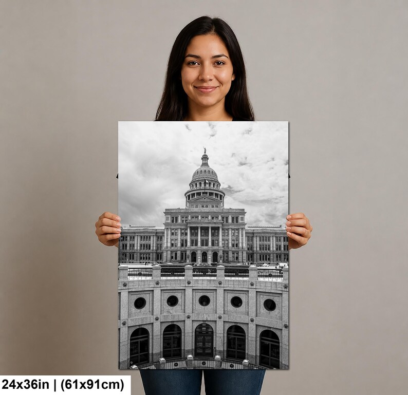 May include: A black and white rectangular wall art print featuring the Texas State Capitol building with its prominent dome and columns, measuring 24 by 36 inches. The architectural photograph captures the structure from a low angle perspective.