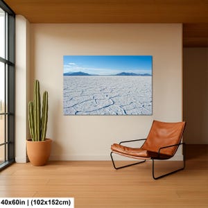 May include: A rectangular wall art print featuring a landscape of the Bonneville Salt Flats with a cracked white salt crust, distant blue mountains, and a clear blue sky. The print measures 40 inches by 60 inches and is displayed on a wall.