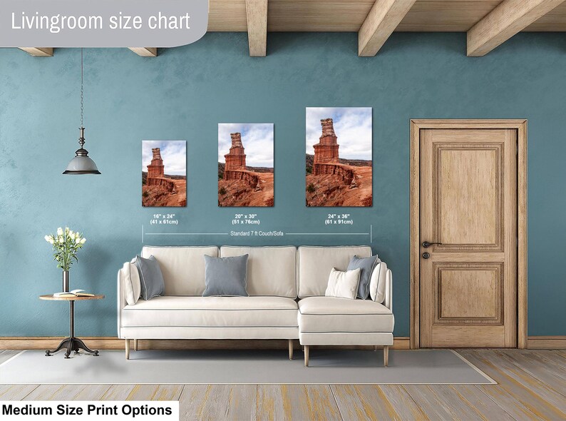 May include: A living room size chart displaying three rectangular wall art prints of a red rock desert landscape. The prints are labeled with dimensions of 16 inches by 24 inches, 20 inches by 30 inches, and 24 inches by 36 inches above a couch.