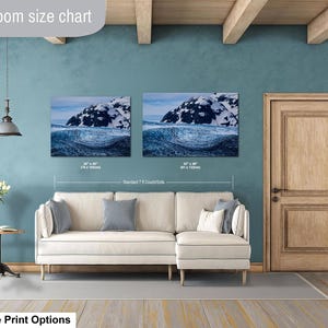May include: A living room size chart displaying two landscape wall art prints of a snowy mountain above a dark blue ocean wave. The prints are labeled with dimensions of 30 by 40 inches and 32 by 48 inches, positioned above a cream-colored sectional sofa.