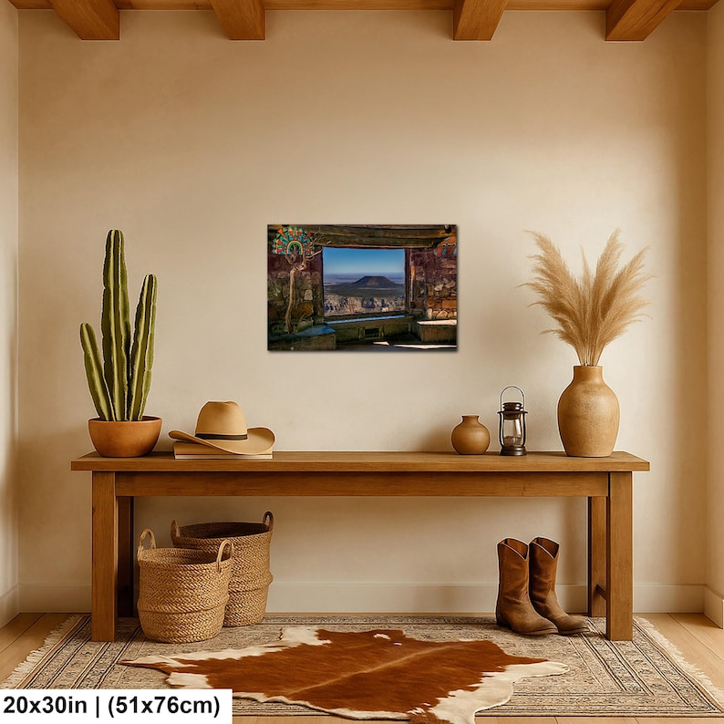 May include: A rectangular wall art print measuring 20 by 30 inches, depicting a scenic canyon landscape viewed through a stone window frame. The artwork features earthy brown and blue tones, showcasing a distant mountain peak under a clear sky.