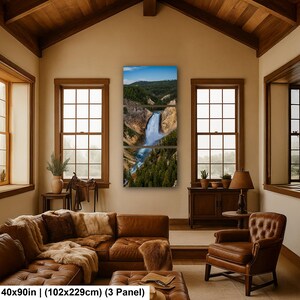 May include: A three-panel wall art set depicting a waterfall cascading through a canyon with green pine trees and rocky cliffs under a blue sky. The text at the bottom reads 40x90 in (102x229cm) (3 Panel).