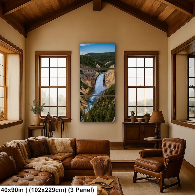 May include: A three-panel wall art set depicting a waterfall cascading through a canyon with green pine trees and rocky cliffs under a blue sky. The text at the bottom reads 40x90 in (102x229cm) (3 Panel).