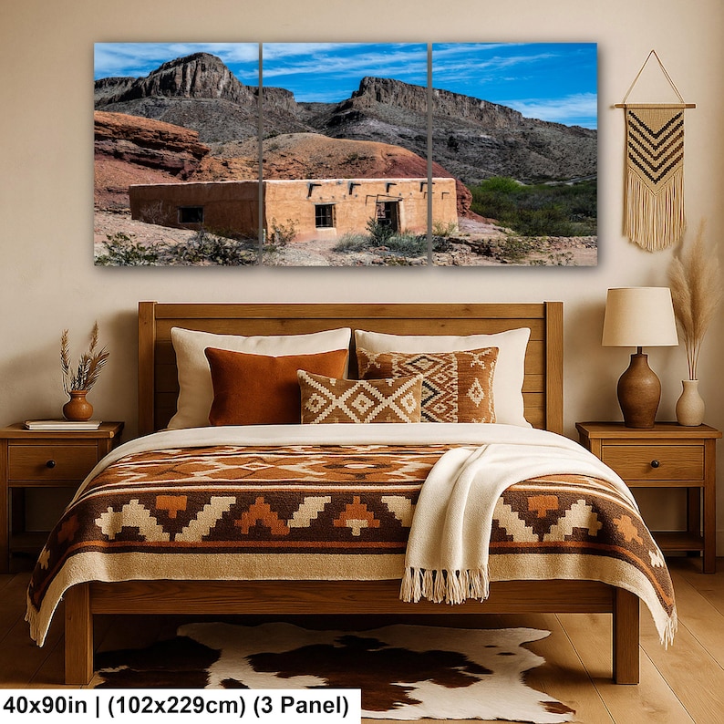 May include: A three-panel wall art set depicting a desert landscape with a tan adobe building against rocky mountains and a blue sky. The artwork measures 40 by 90 inches. The scene includes earthy tones, rugged terrain, and clear blue skies.