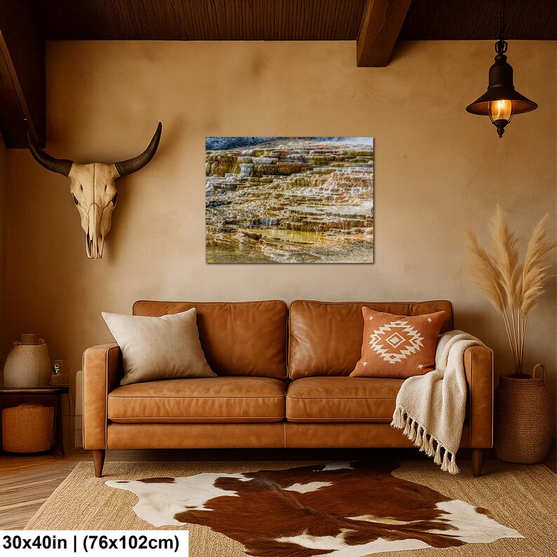 May include: A rectangular wall art print depicting a terraced landscape with flowing water, mounted above a brown leather sofa. The print measures 30 inches by 40 inches. The scene features layered rock formations in shades of brown, tan, and white.