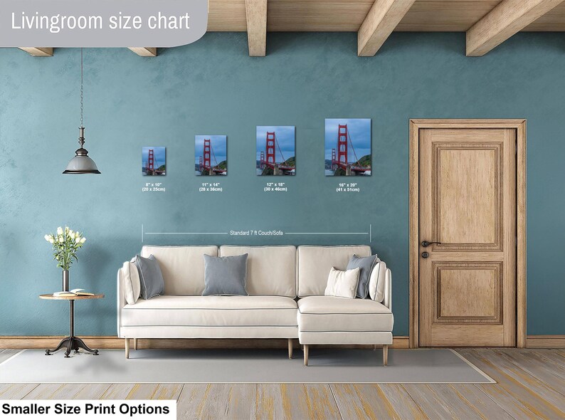 May include: A living room size chart displaying four framed prints of the Golden Gate Bridge in sizes 8x10, 11x14, 12x18, and 16x20 inches, positioned above a cream-colored sectional sofa. The text reads Livingroom size chart and Standard 7 ft Couch/Sofa.