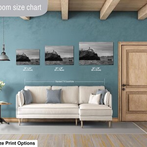 May include: A living room size chart displaying three black and white landscape prints of a lighthouse on a cliff. The prints are labeled with dimensions of 18 by 24 inches, 20 by 30 inches, and 24 by 36 inches, positioned above a beige sectional sofa.